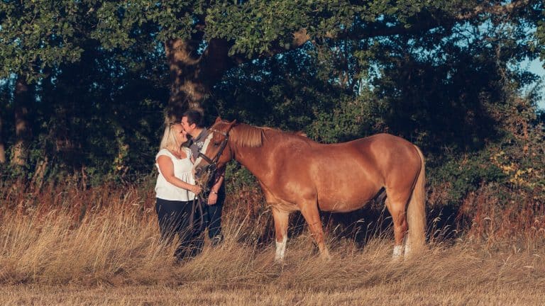 Gemma and Jake with their horse during their pre-wedding shoot in summer 2022