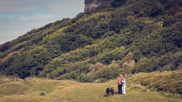 Alice and Daniel with their Doberman puppy dog at Windy Gap during their pre-wedding shoot the day before we provided them with their wedding photography at Ventnor Botanic Garden on the Isle of Wight.