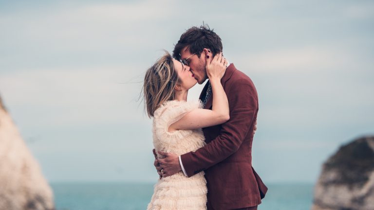 Katie and Simon looking chic, kissing at Freshwater Bay during their pre-wedding shoot